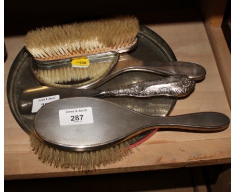 A silver three-piece dressing table set with engine turned decoration and a silver handled shoe horn