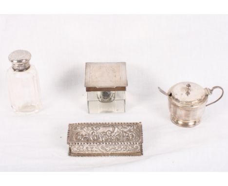 A square glass inkwell with engine turned silver top, a dressing table jar with silver cap, a silver mustard pot and spoon an