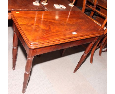 A 19th Century mahogany rectangular fold-over top card table inset circular baize panel, on turned supports, 33" wide