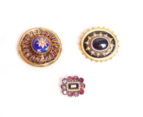 A Victorian gold, seed pearl and black enamel mourning brooch set polished agate cabochon, a Victorian gilt metal and blue en