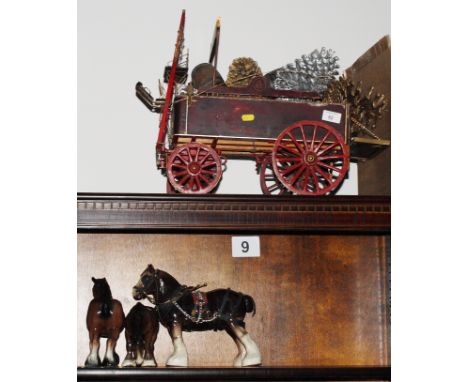 A wooden model of a dray and three pottery horses