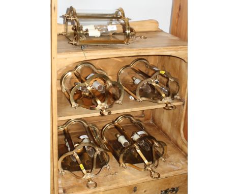 A set of five brass framed two-light wall lanterns with triple convex glass fronts, 18" high