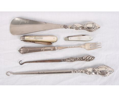 Two silver and mother-of-pearl folding fruit knives, two button hooks with silver handles, a similar shoe horn and a silver h