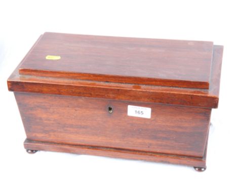 A 19th Century mahogany sarcophagus-shaped tea caddy with two tea compartments and central glass mixing bowl, 13" wide