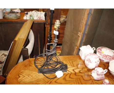 A wrought metal table lamp in the form of a Penny Farthing and rider 