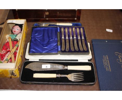 A pair of cased plated fish servers, a plated cake knife and fork and a set of six silver handled dessert knives