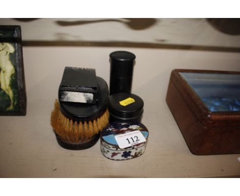 A small cloisonne box and cover, four pieces of ebony dressing table ware and a Zippo lighter