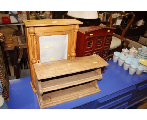 A pine spice rack; a shallow pine safe cupboard; and another wall cabinet in the form of a house