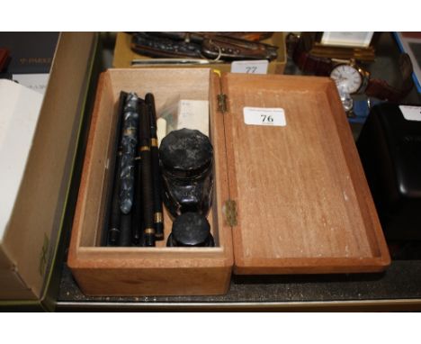 A wooden box and contents of various vintage fountain pens, ink bottles etc