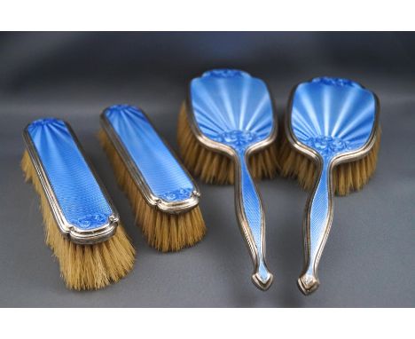 A silver and blue enamel four piece dressing table set comprising of a pair of hair brushes and a pair of clothes brushes, Bi