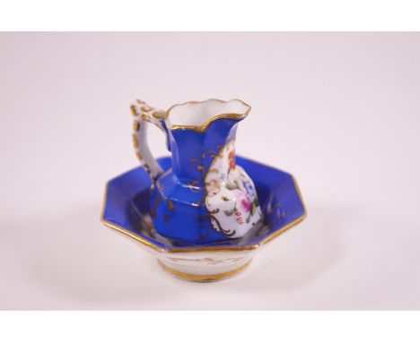 A Coalport porcelain miniature jug and basin, painted with flower sprigs on royal blue ground, the jug 5cm high