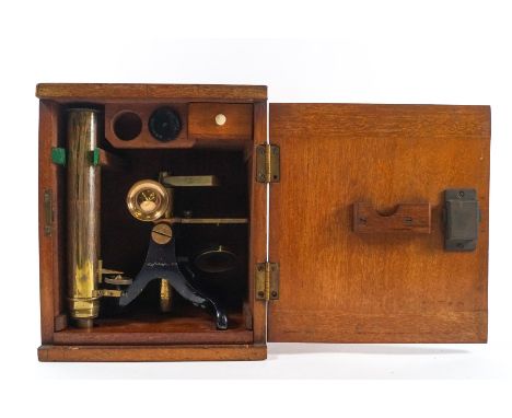 An early 20th century brass and lacquered microscope, with blanks slides and additional lens, stamped R Winkel, Gottingen, ma