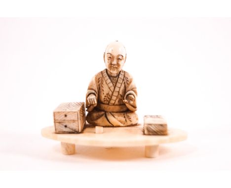 An early 20th century Japanese ivory netsuke, carved as a seated man on an oval base, unsigned, 4cm high 