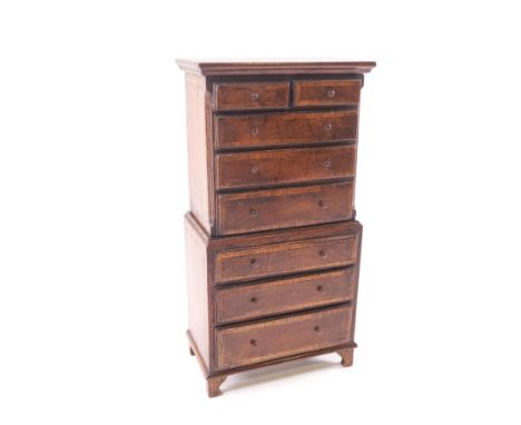 A doll's house cross-banded mahogany chest on chest, two short over six long drawers on bracket feet, 23.5cm high x 12.5cm wi
