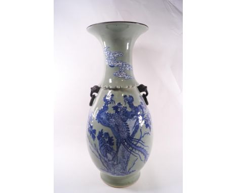 A large Chinese celadon table lamp, decorated with mythical birds and flowering plants, masks and ring handles, 59cm high