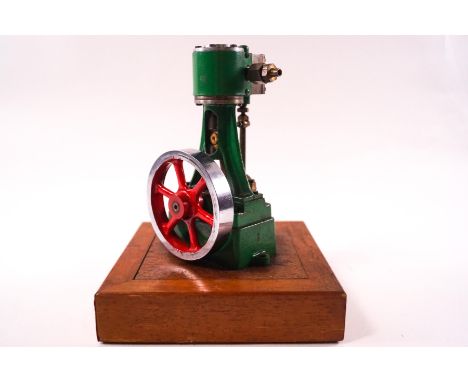 A Stuart Turner No.10 stationary steam engine, 15cm high, mounted a wooden plinth