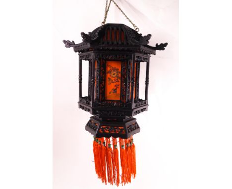 A 1930s Chinese lantern of pagoda style, the pierced wood frame with painted orange silk panels depicting birds among foliage