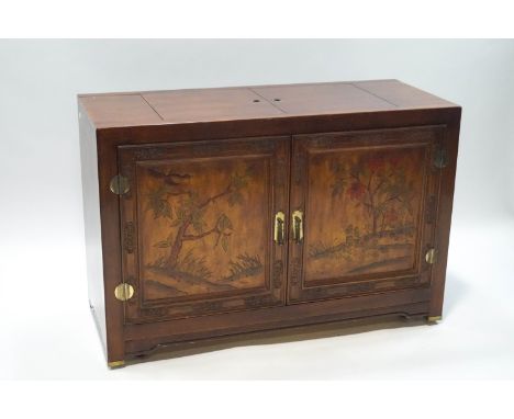 A Chinese hardwood buffet with carved and stained decoration of trees and plants, 79cm high x 117cm wide x 48.5cm deep