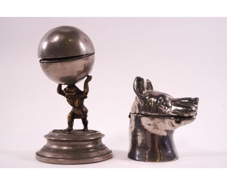 A plated inkwell of a dogs head with ceramic liner, 8.5cm high, and a pewter inkwell of 'Hercules', 13.5cm high