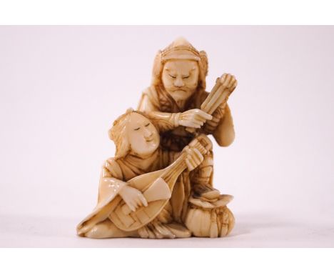 An early 20th century ivory netsuke, carved as a warrior with a courtesan playing a stringed instrument, unsigned, 4.5cm high