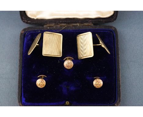 A pair of cufflinks with engine turned finish and three engraved dress studs. All marked for 9ct gold. Gross weight: 10.0 gra