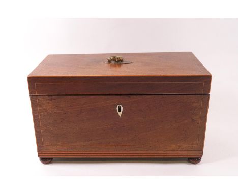 A George III mahogany tea caddy, circa 1830, with decorative boxwood stringing and ivory escutcheon, triple compartment on bu