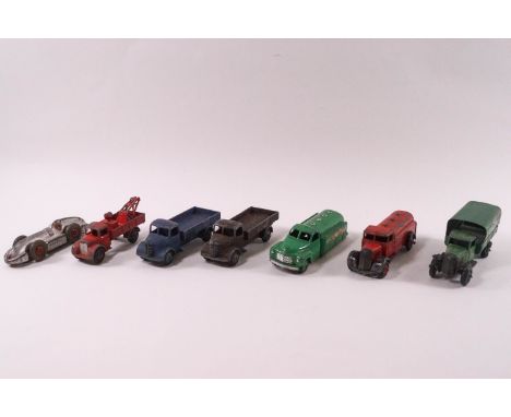 Seven 1940's/50's Dinky die-cast vehicles: two Austins trucks, pick up truck, two petrol carriers, a green livery truck and a