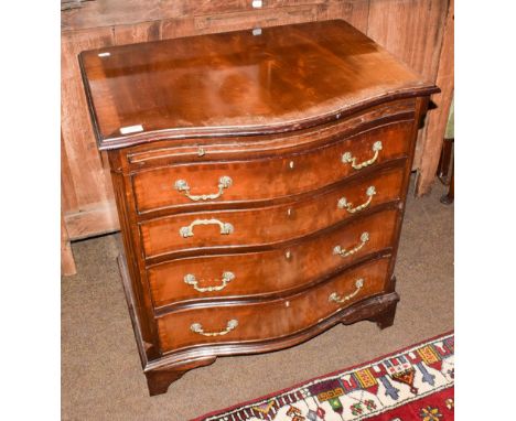 A Georgian style mahogany serpentine chest of drawers, brushing slide above four long drawers, bracket supports, 70cm by 49cm