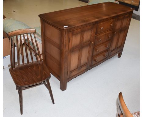 A dark elm Ercol style sideboard, 146cm by 52cm by 90cm high; together with a similar single stick-back chair 