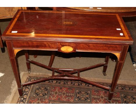 A George III mahogany and satinwood inlaid fold-over card table, rectangular form, swivel top, square tapered legs, elaborate