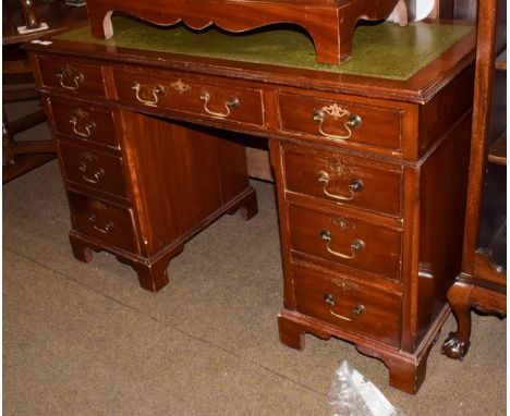 A 20th century mahogany twin-pedestal desk, green leather inset, arrangement of nine drawers, bracket supports, 120cm by 55cm