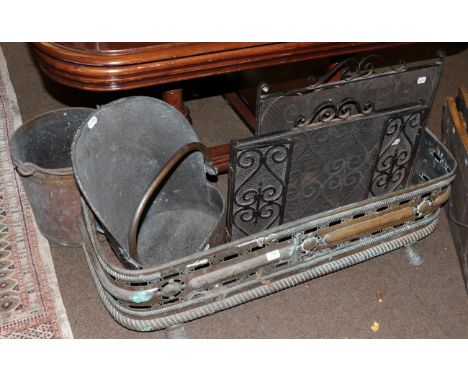 A 19th century cast metal fender, 112cm wide (external), 109cm (internal), two copper coal buckets and a pair of 20th century