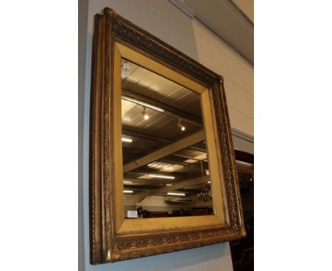 A 19th century gilt and gesso picture frame, with later mirror insert, 72cm by 83cm high  .  Various cracks, restoration and 