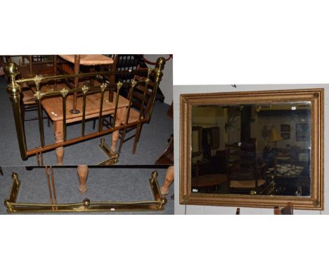 A brass double bed-head; a brass fender; and a modern mirror (3)