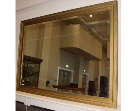 A large gilt hall mirror, the bevelled glass plate within a conforming Greek key decorated frame, 182cm by 131cm 