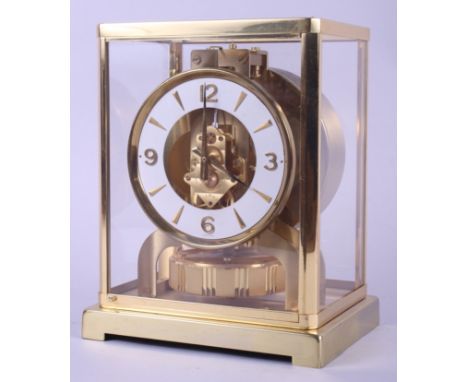 A gilt and glass cased Jaeger-LeCoultre Atmos mantel clock with white enamel dial and Arabic and baton numerals, 8 3/4" high