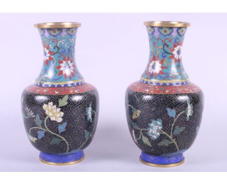 A pair of Chinese cloisonne vases with floral decoration on a dark ground, 8" highCondition: both have small losses to the en
