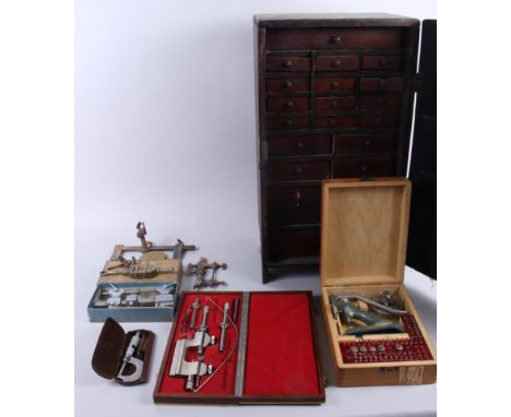 A twenty-drawer clock maker's chest, containing watch parts, various tools, including a small precision lathe, vices, etc