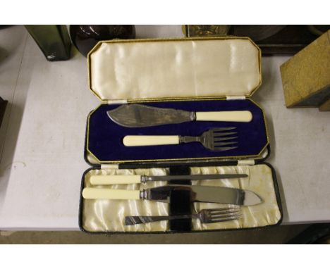 A pair of fish servers together with a silver plated fork; a knife; and a sharpening tool