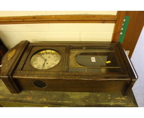 A 1930's oak two hole wall clock 