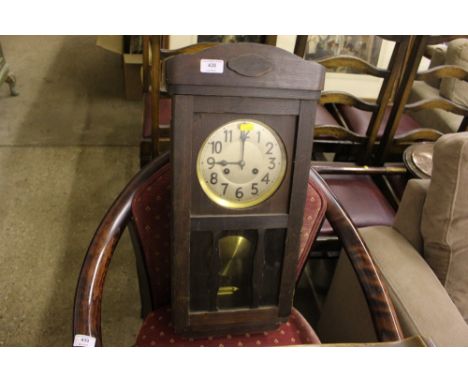 A 1930's pine cased two hole wall clock 