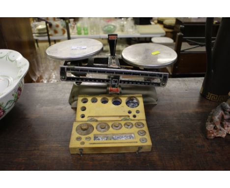 A set of balance scales and a box of weights