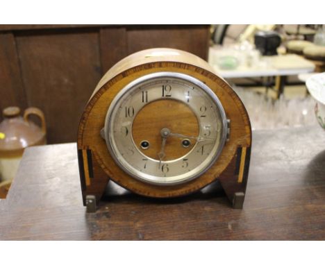 An Art Deco walnut two hole mantel clock- pendulum on rostrum