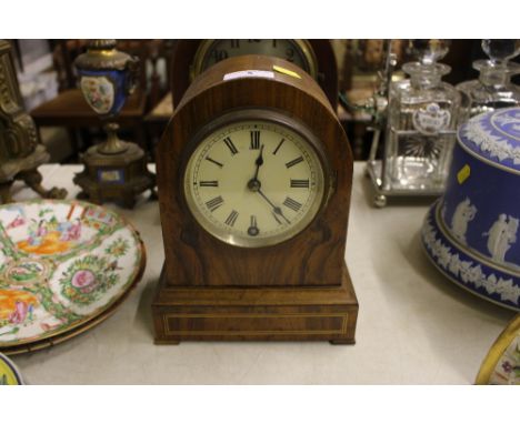 An early 20th Century walnut and inlaid single hole mantel clock 