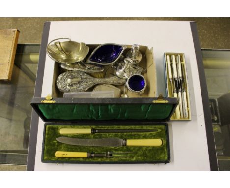 A tray containing two silver mounted brushes; a silver dwarf candlestick; two enamel decorated brooches; various platedware; 