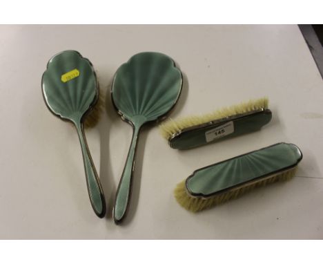 A silver and green enamel decorated four piece dressing table set 