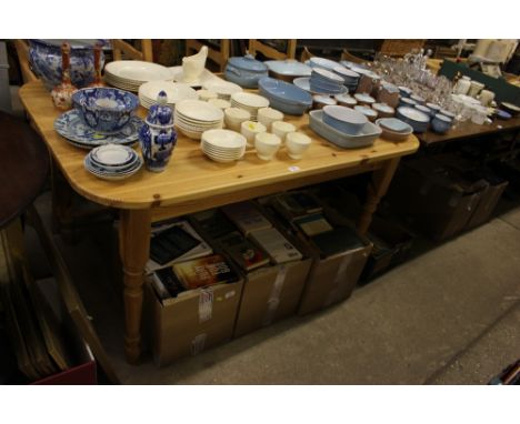 A pine kitchen table with a set of four ladder back chairs 