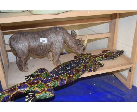 Model rhino and a painted wooden salamander