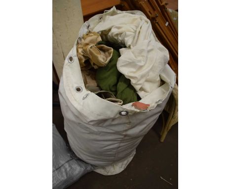 A large bag of various army surplus clothing and others