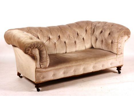 A Victorian Chesterfield sofa, circa 1890, with upholstered frame and turned feet, 74cm high x 183cm wide x 92cm deep
